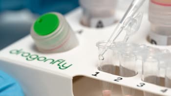 A researcher using a pipette to test samples on Dragonfly, a point-of-care molecular diagnostic platform.